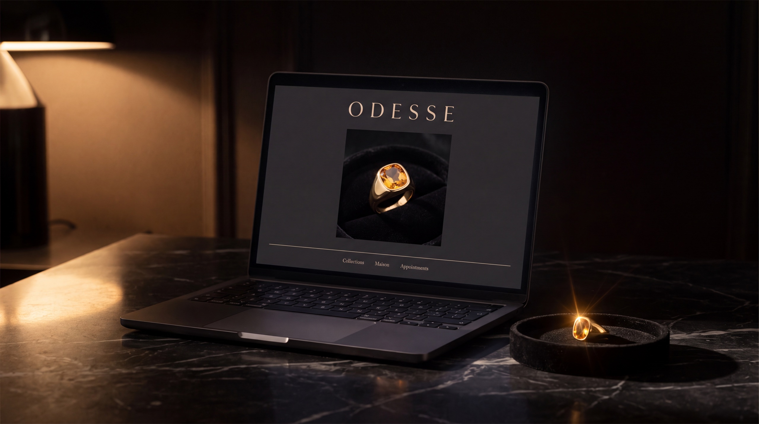 Odesse — the maison's e-commerce site on a laptop beside the citrine ring